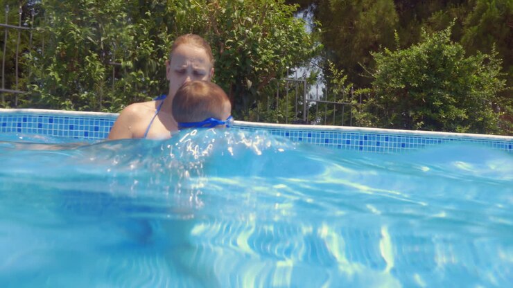 Mother Teaching Son Swimming