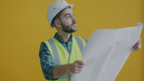 construction worker reviewing building plans