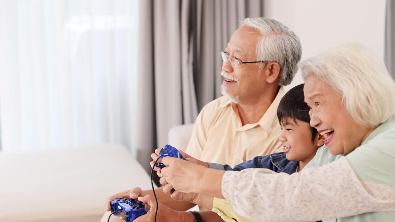 Elderly couple and child joyfully play video games together in a bright living room