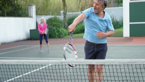 senior man playing tennis in tennis court 4k