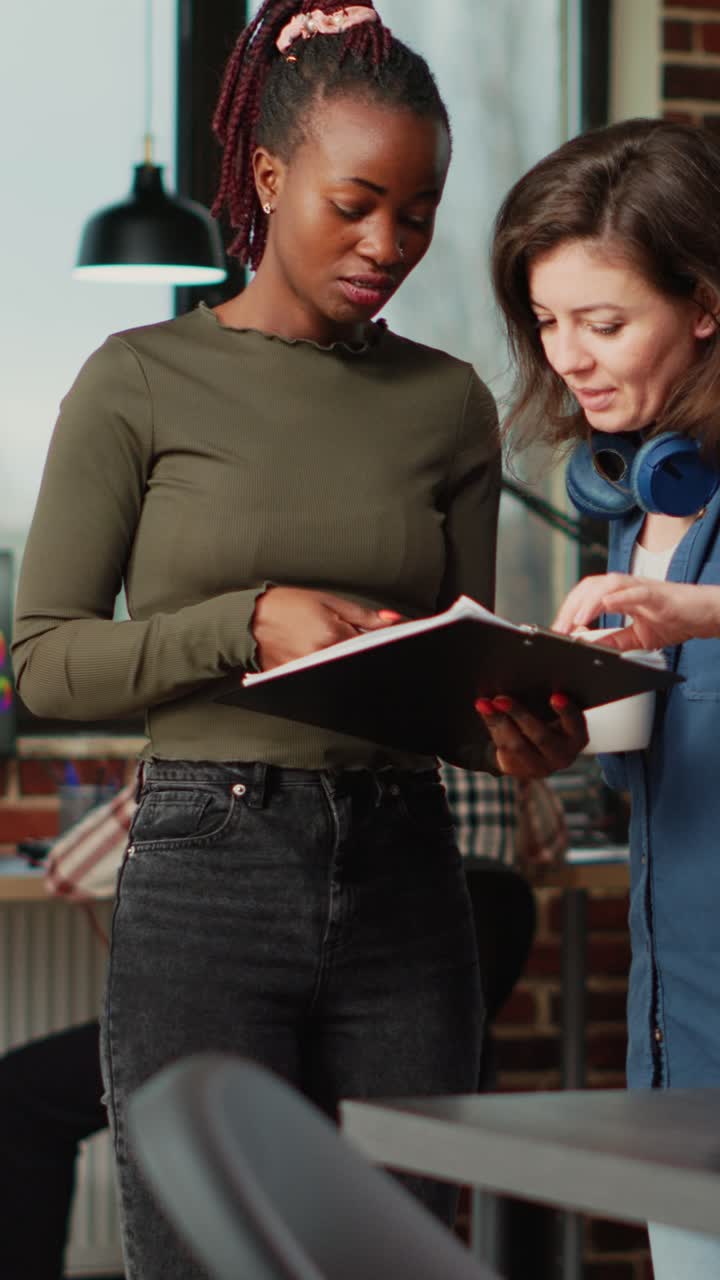 Vertical video: Team of diverse office employees brainstorming ideas in creative agency