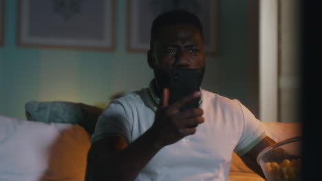 man watching movie on phone