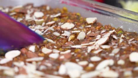 Closeup-Of-Sweet-Caramel-Banana-Cake-Topped-With-Almond-Nuts-Being-Sliced