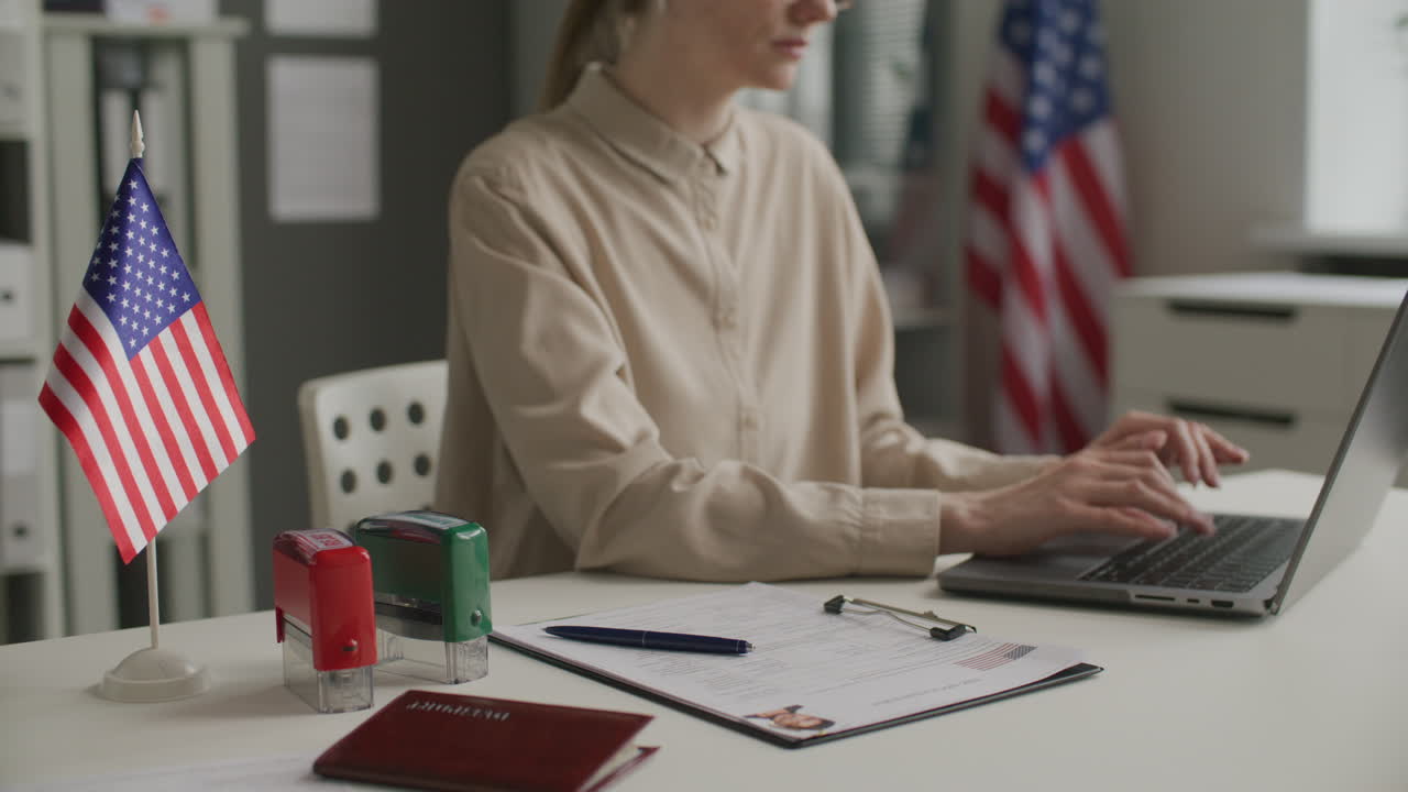 Female Visa Officer Reviewing Application Form and Stamping Approval