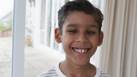 Portrait-of-happy-biracial-boy-at-home,-slow-motion