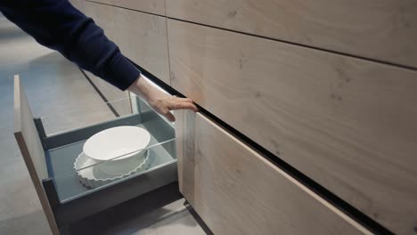 a wood kitchen showroom gimbal shots of drawers being opened