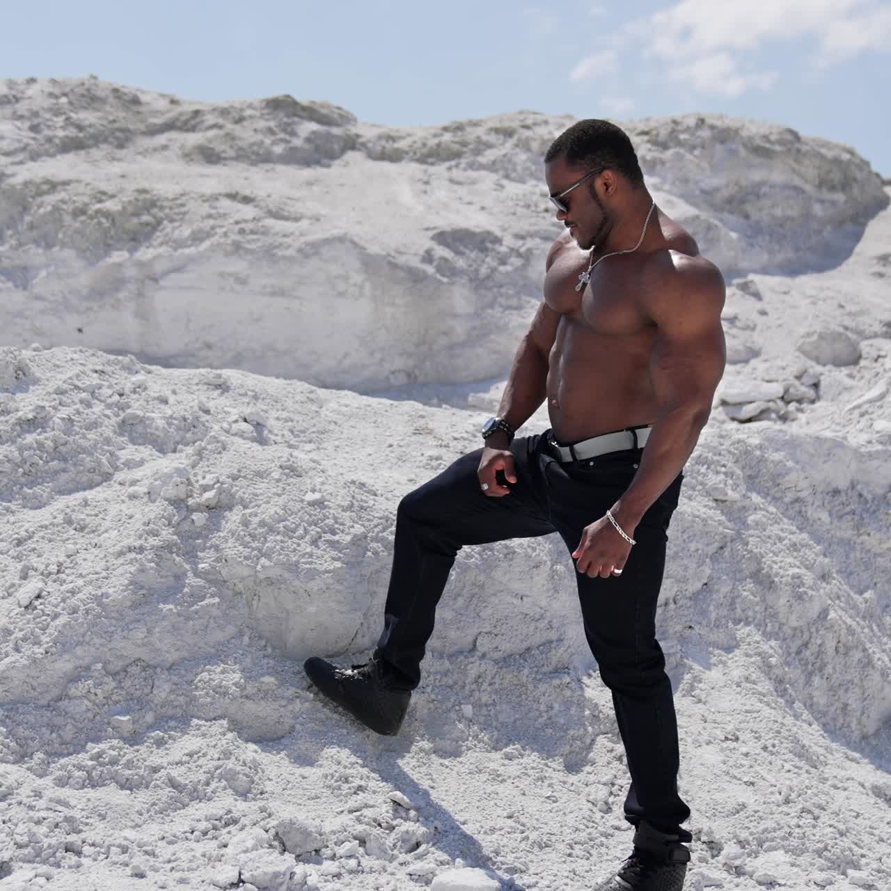 Fit young man with beautiful torso. Naked torso of african american man posing outdoor