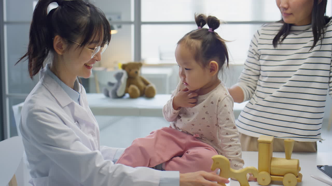 Asian Toddler Girl Visiting Pediatrician with Mom