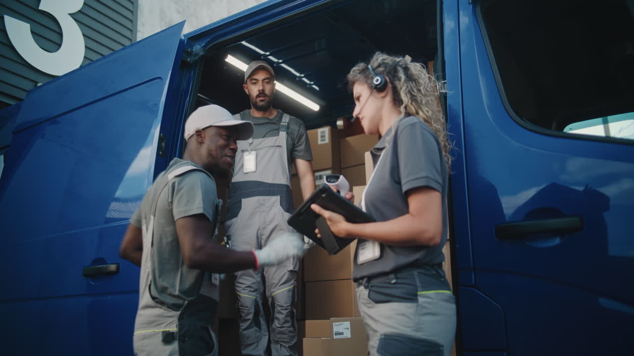 Logistics Team Managing Deliveries and Loading Packages from a Commercial Van