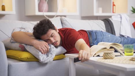 lazy man falling asleep with tv remote in hand.