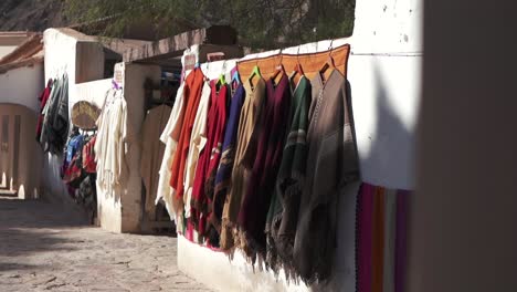 Traditional-souvenir-sales-business-displays-native-Argentine-clothing-on-the-exterior-wall