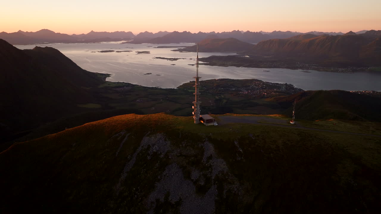 TV and radio tower atop Storheia mountain during sunset in Stokmarknes. Aerial