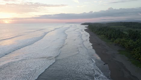 high aerial view over the pacific ocean and the surf on the sandy beach of playa bandera in costa rica