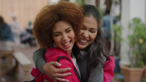 portrait of young woman suprise hugging friend girlfriends laughing embracing enjoying togetherness urban youth friendship