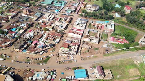 Aerial-view-of-cars-and-people-at-a-Open-Air-Market,-in-Africa---reverse,-drone-shot