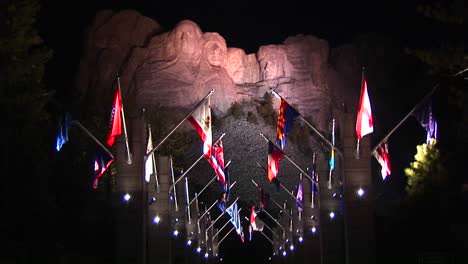 a night look at mt rushmore in lights with the avenue of flags in the foreground