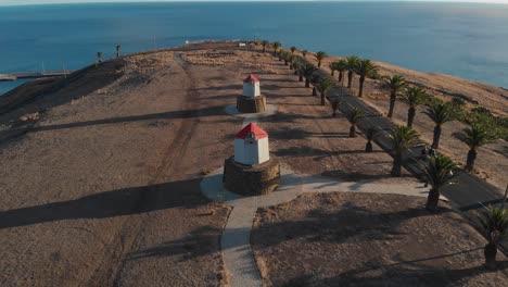 Aerial-forward-over-abandoned-windmills-in-Porto-Santo-island,-Portugal