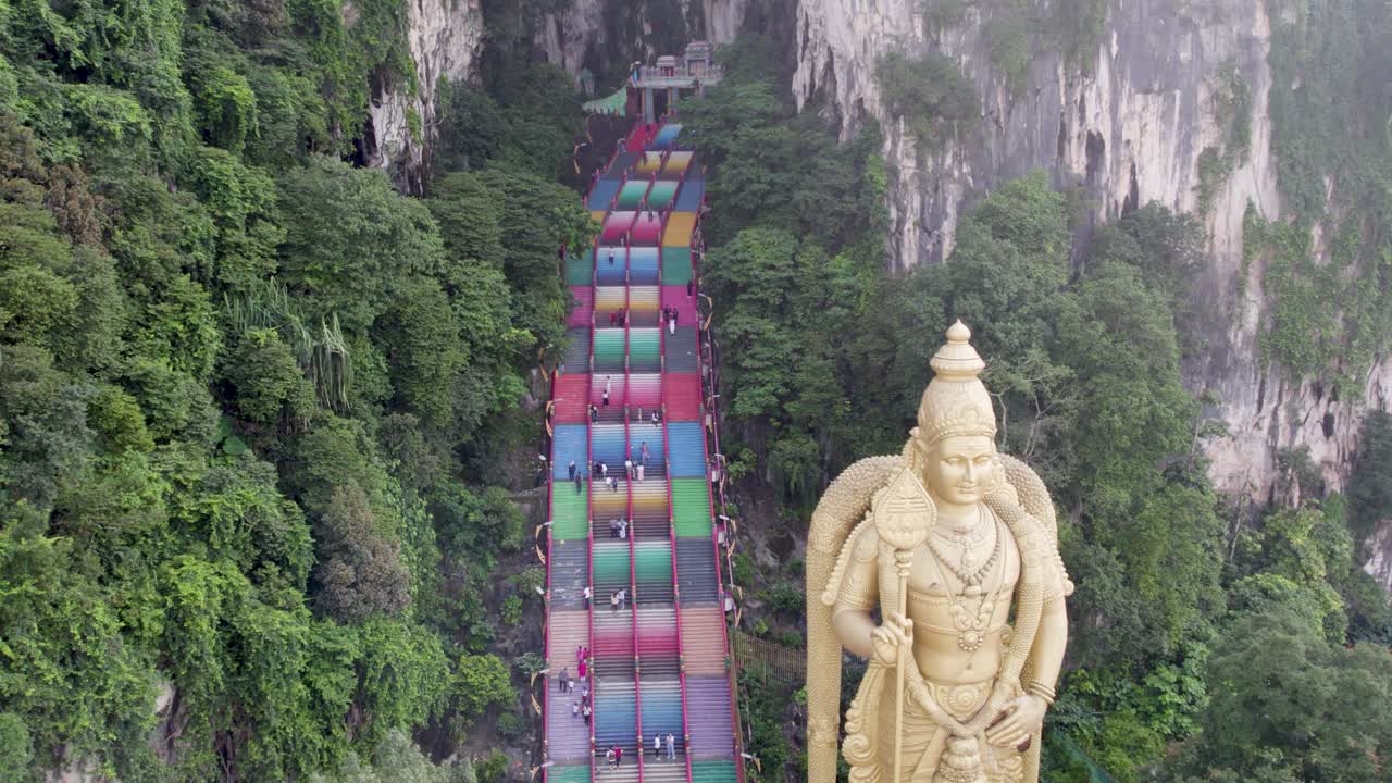 Drone rotating counterclockwise to capture Malaysia's Kuala Lumpur Batu Caves and the Lord Murugan statue