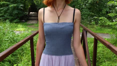 woman walking on a wooden bridge in a park