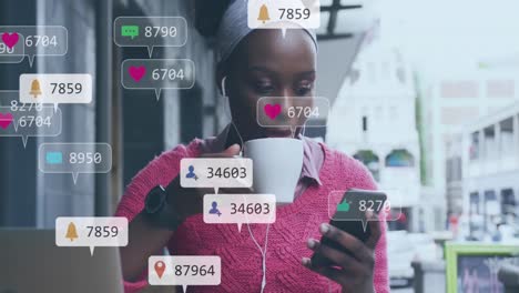 Animation-of-social-media-icons-and-numbers-over-african-american-woman-using-smartphone