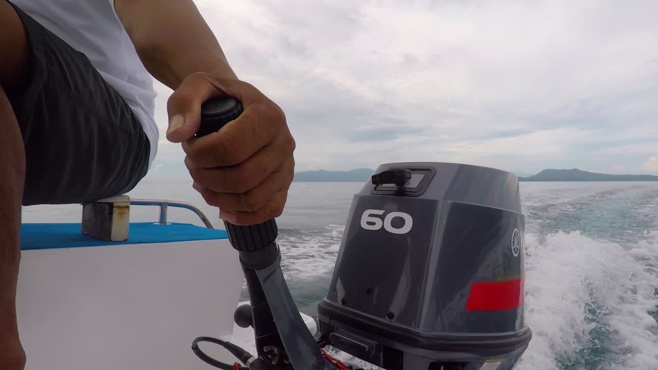 Man Holding The Speed Boat Engine, Navigating In The Sea