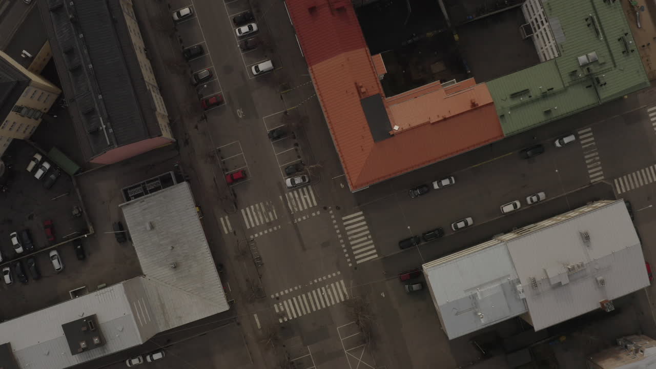 Flying above residence building roofs.