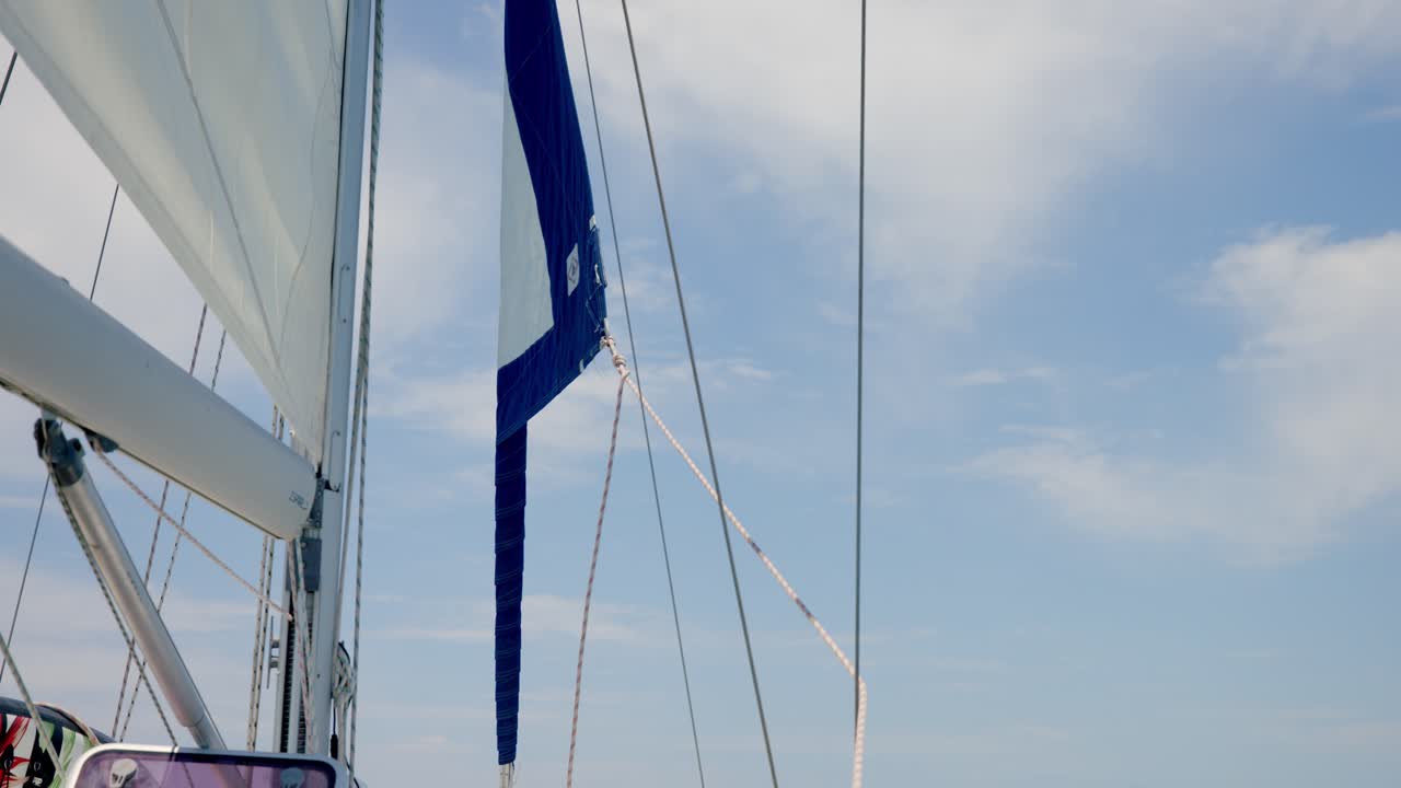 Man Pulling Rope On Sailboat Winch With Detachable Crank. - close up