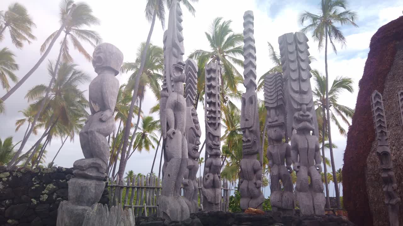 Gimbal wide panning shot of tiki statues at Pu'uhonua O Honaunau National Historical Park in Hawai'i