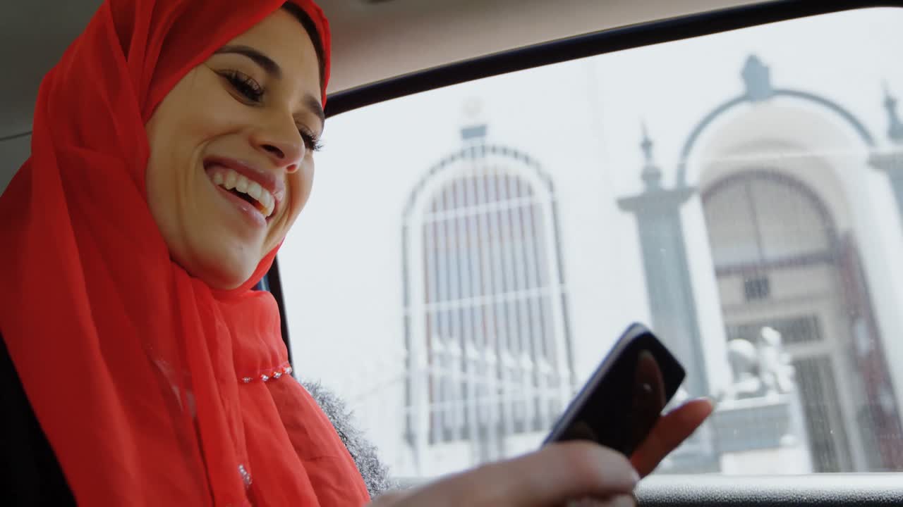 Woman in hijab using mobile phone 4k