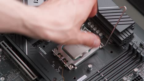 man installing a cpu on a motherboard