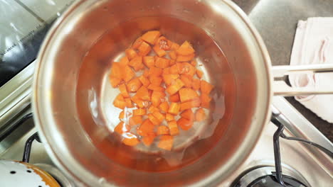 Pooring-chopped-carrots-in-the-pan-with-water