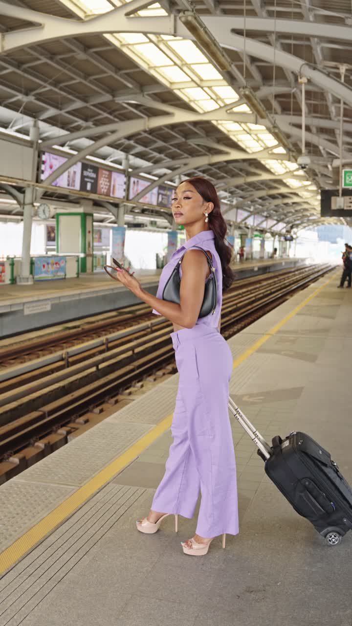Woman at a train station with luggage
