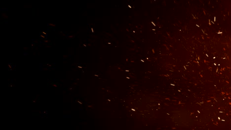 burning hot sparks rising from large fire in night sky. side movement. abstract isolated fire glowing particles on black background slow motion. looped 3d animation.