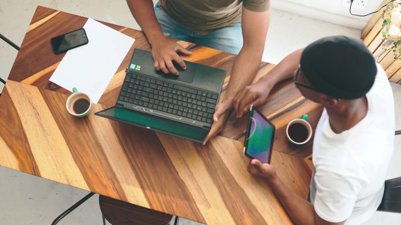 two young men chatting over coffee in a coffee