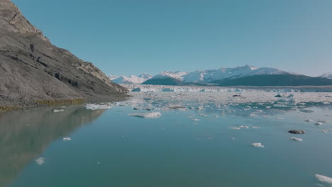 aerial view flying over an icy lake in the stunning arctic wilderness of alaska