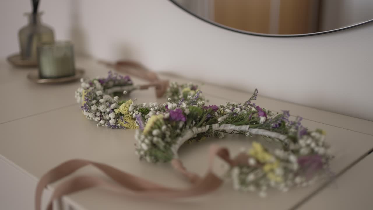 delicate flower crown with pastel ribbon placed on a dresser in soft natural light