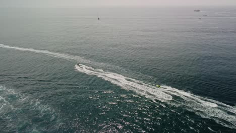 Jetskis-on-the-sparkling-waters-near-puerto-banus,-marbella,-with-clear-skies,-aerial-view