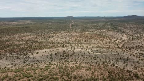 forward moving drone shot of a dry game farm during drought near okahandja, namibia