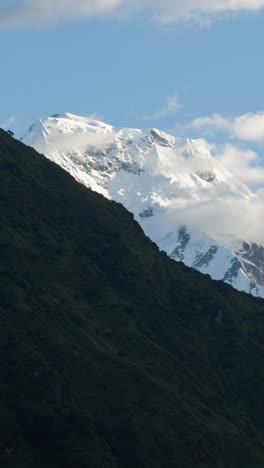 himalayas timelapse of mountains scenery, beautiful nepal scenery vertical video for social media instagram reels and tiktok, close up clouds moving over snowcapped summits landscape