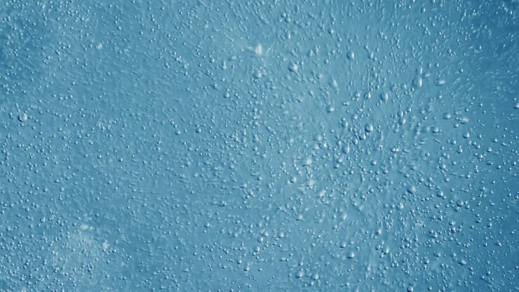 Oxygen bubbles in water on a blue abstract background