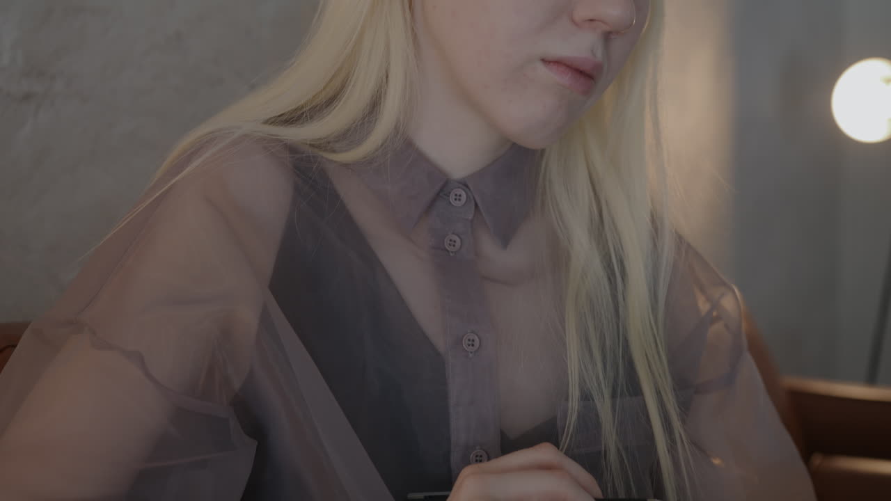 Woman with blonde hair sitting and working