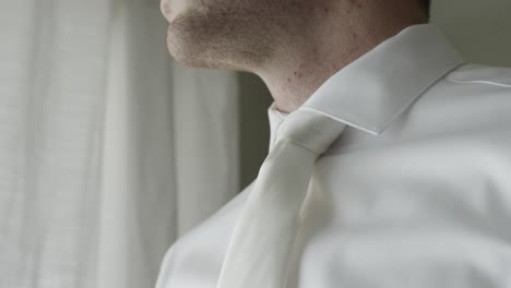 close up shot of groom looking out the window