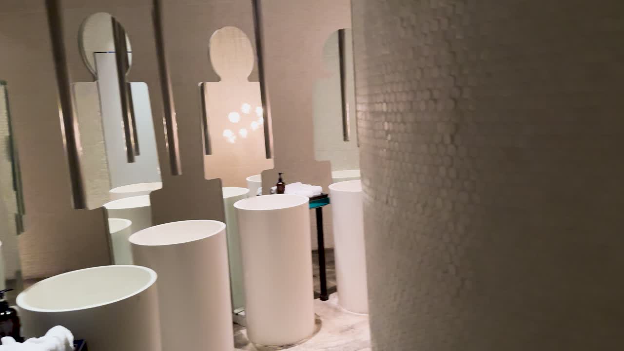 A detailed walkthrough of a luxury men's bathroom featuring elegant design, modern fixtures, and ambient lighting