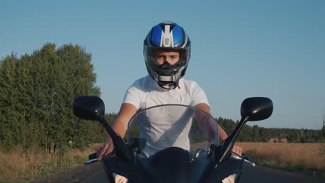 young man rides a motorcycle on the highway