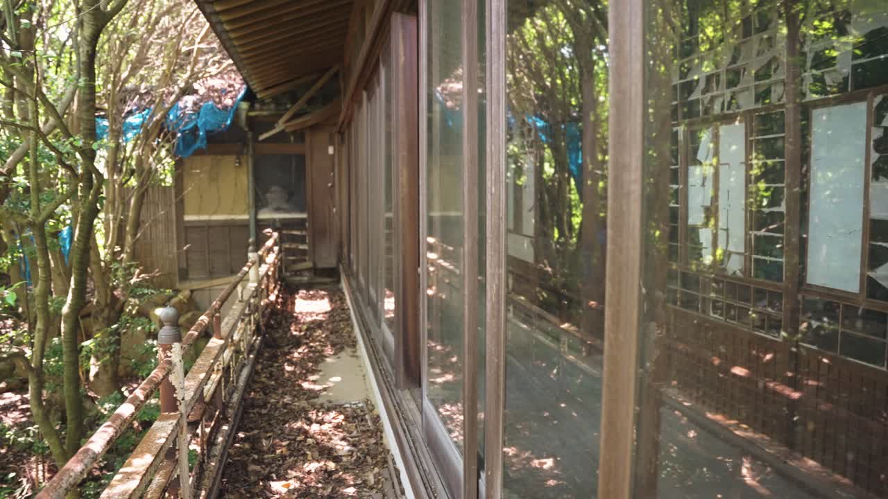 Looking into Window of Ruined Abandoned House in Japanese Countryside