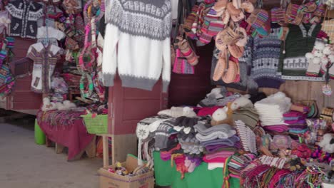 panning shot of traditional woman (cholita) weaving in the recoleta market, sucre