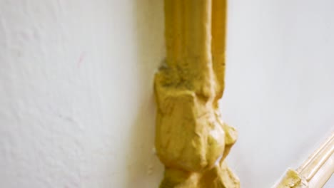 close-up shot of plaster framing resembling wooden moldings, prepared to receive gold leaf treatment, inside a school of architecture in mexico city