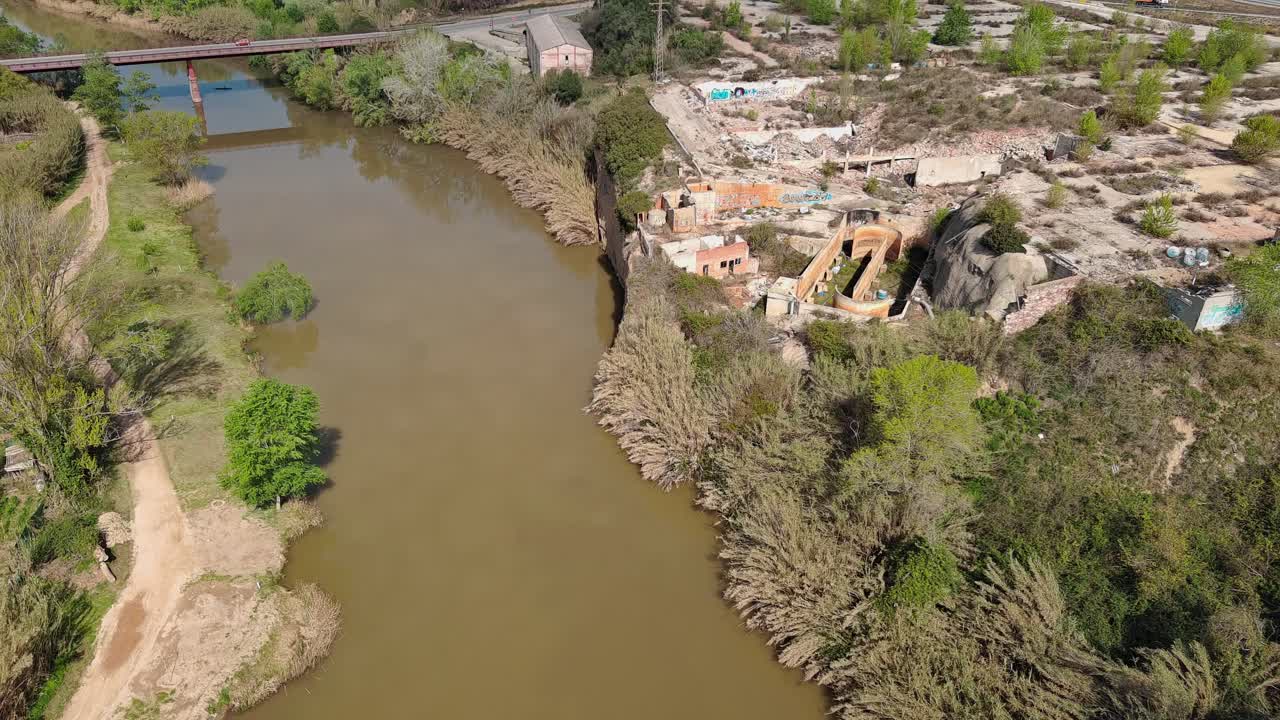 Aerial view of Llobregat river next to abandoned factory. Olesa de Montserrat