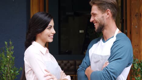 Male-waiter--and-female-waitress-standing-with-arms-crossed-4k