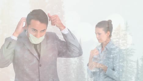Animation-of-man-putting-face-mask-woman-coughing-against-winter-scenery